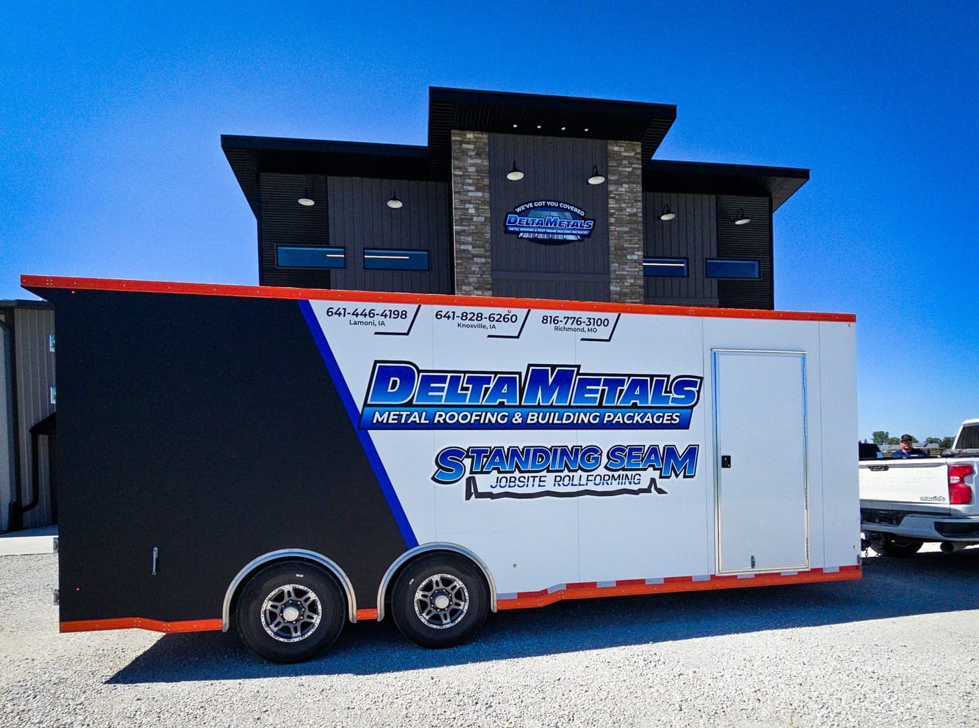 Post-frame building with standing seam roof panels loaded for delivery